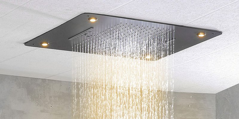 A luxurious ceiling-mounted rainfall showerhead delivering a wide, gentle cascade of water for a spa-like experience.