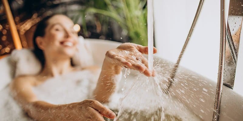 woman relaxing bath with bubbles