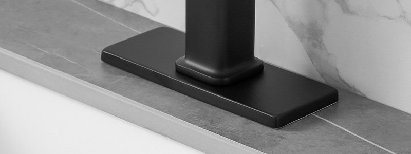 A matte black deck plate install with a bathroom faucet