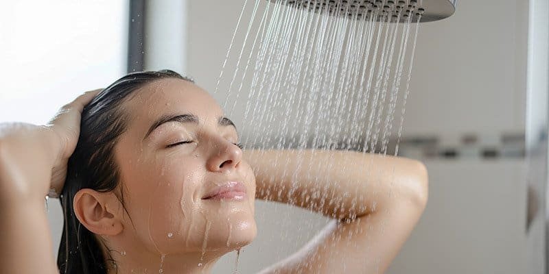 a woman is enjoying a shower